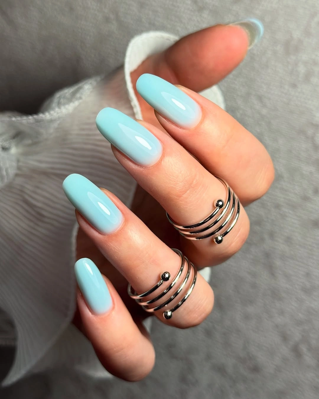Long almond nails in glossy soft aqua blue