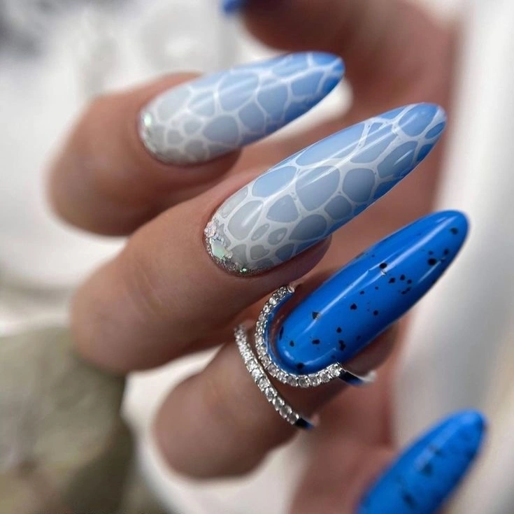 Long blue almond nails with repeated pale curved lines
