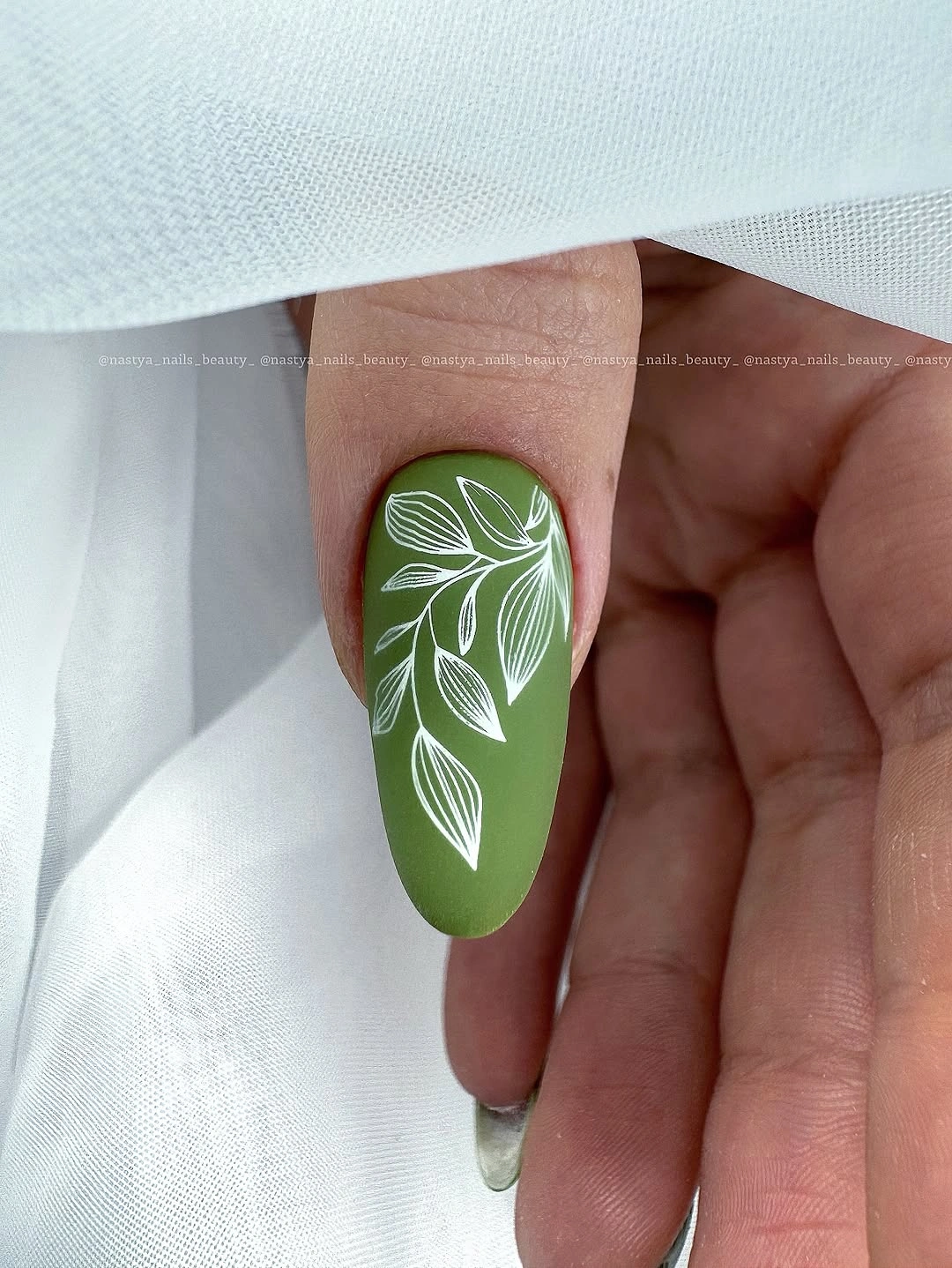 Medium olive nail with open white botanical line art