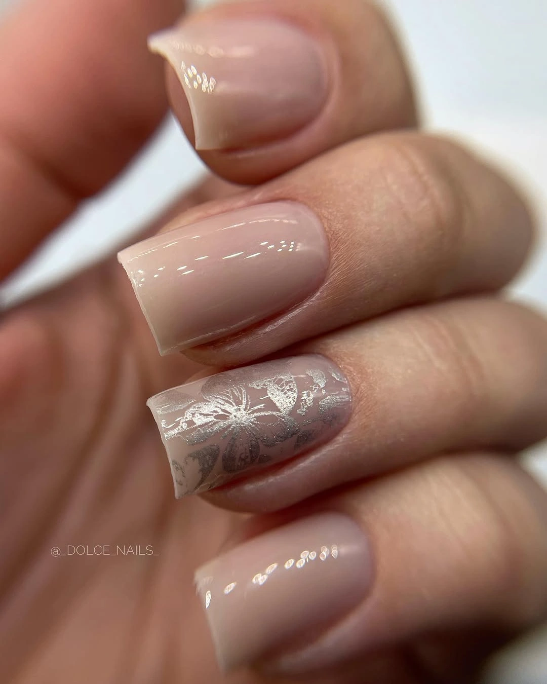 Short nude square nails with a delicate pale silver accent