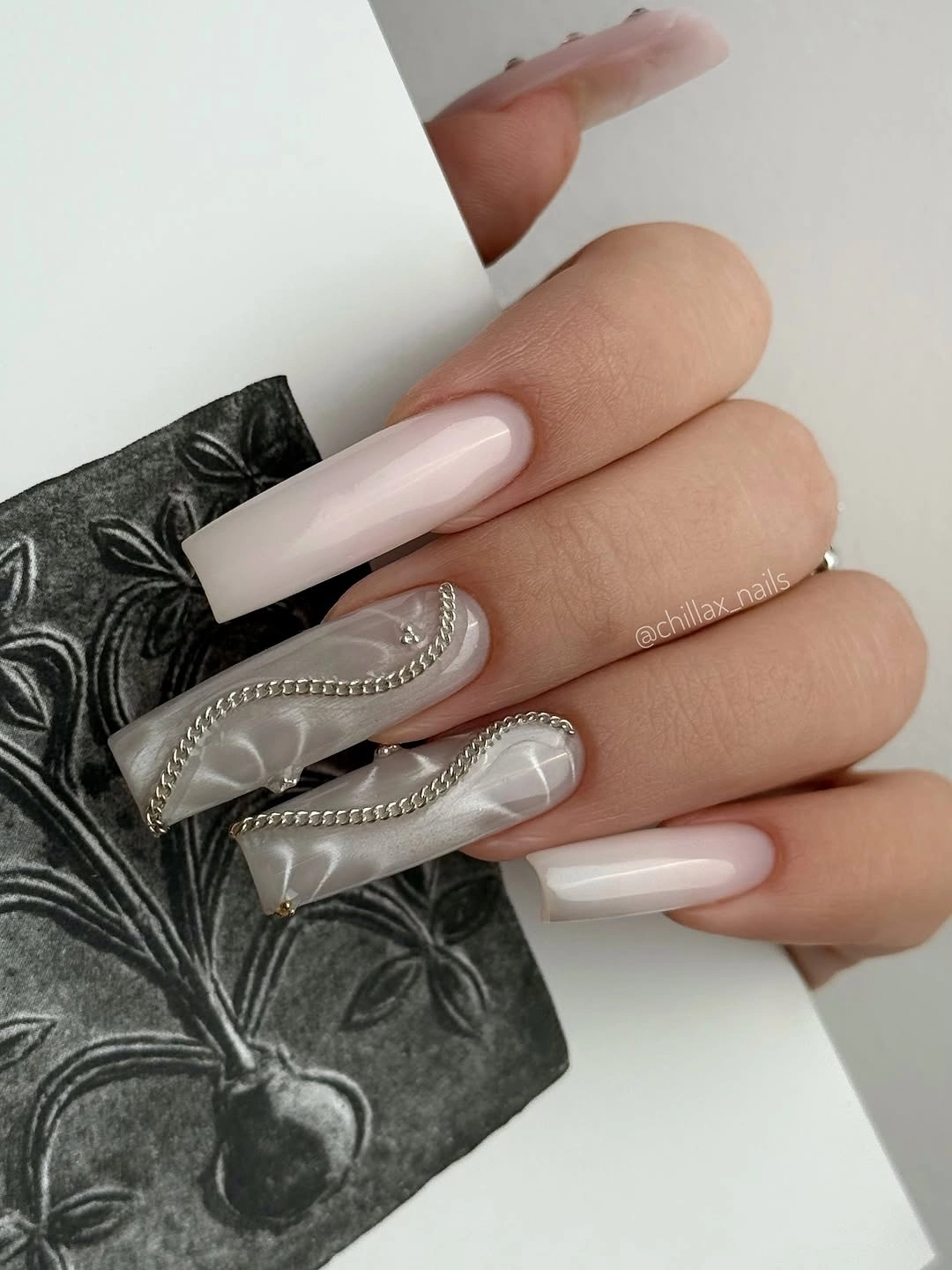 Long translucent gray white nails with silver edge accents