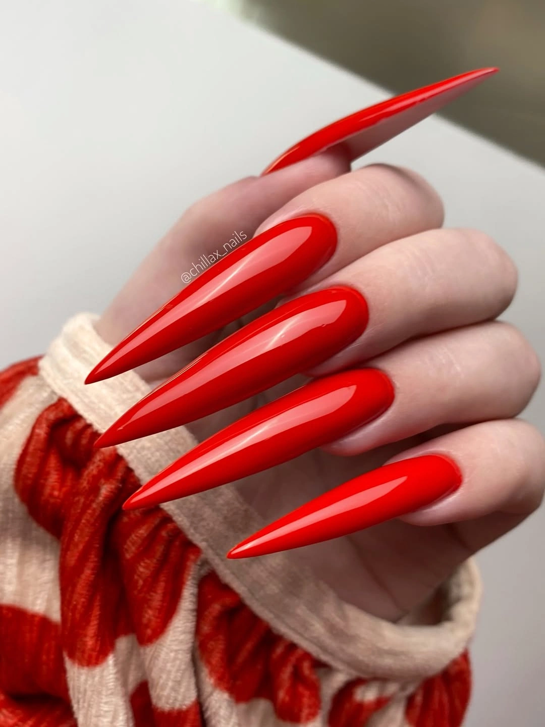 Long bright red almond nails with high gloss