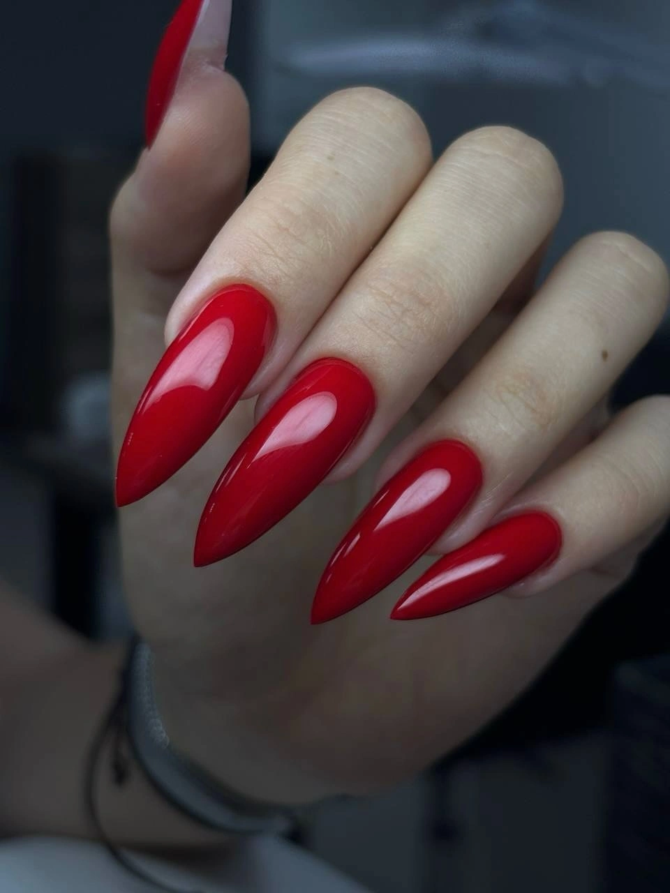 Long glossy red almond nails with smooth curved tips