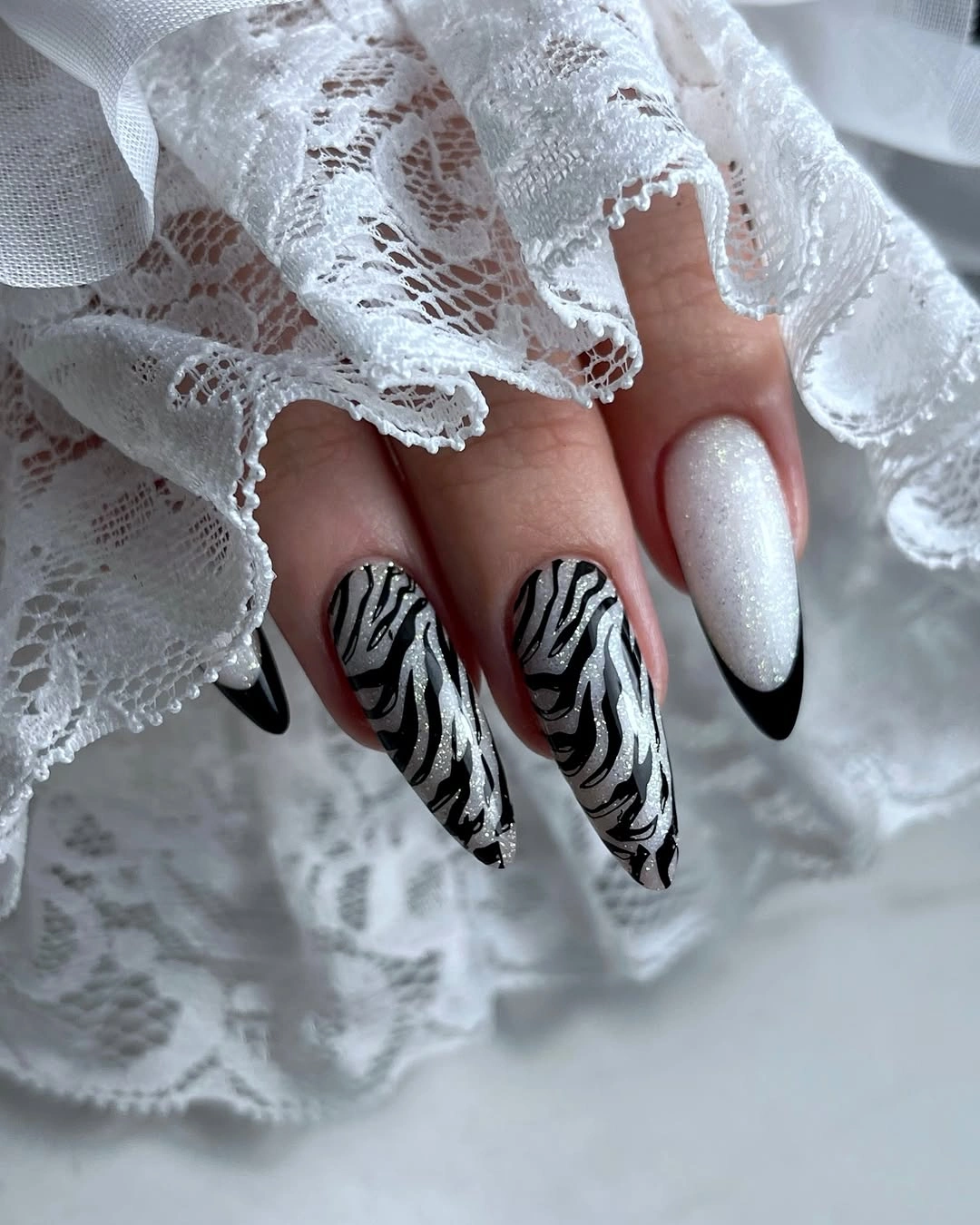 Long almond nails with black and white zebra stripes