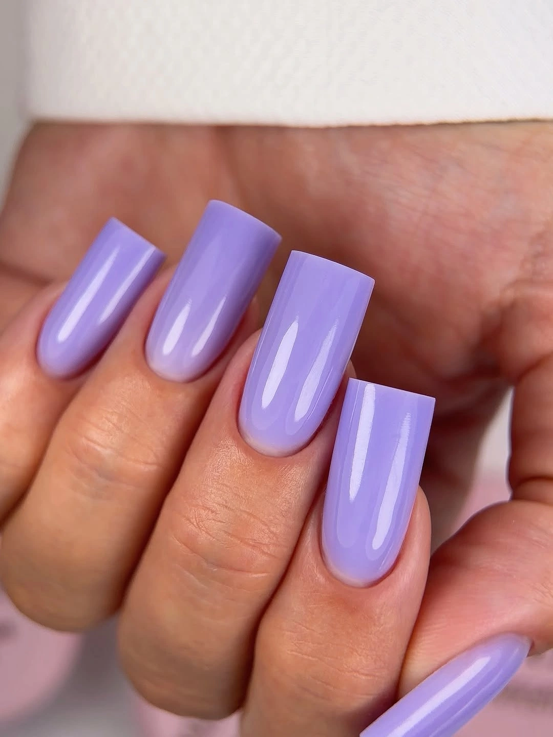 Long glossy lavender square nails with clean reflective highlights