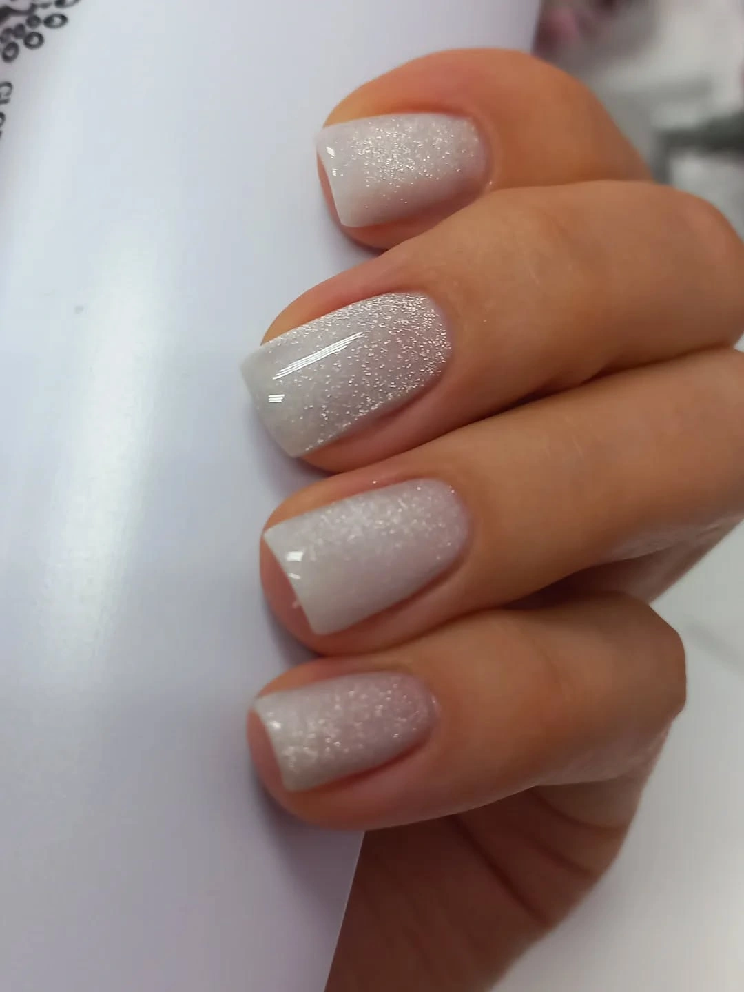Soft off-white rounded nails with fine pearly shimmer