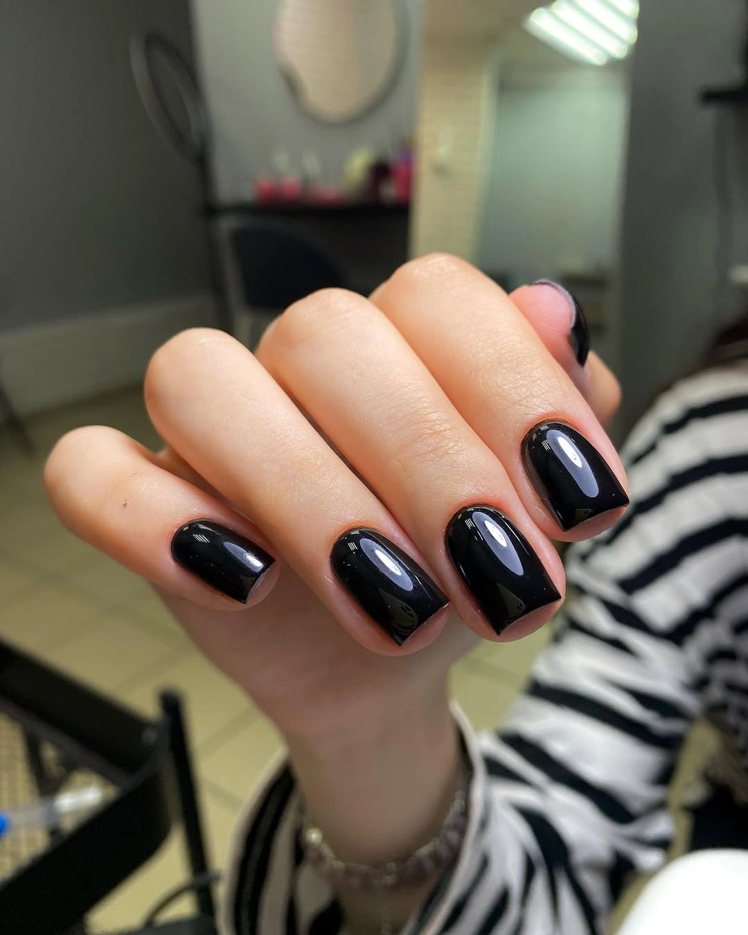 Short glossy black rounded-square nails