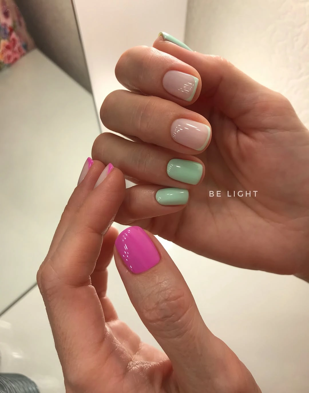 Short mint green nails with vivid hot pink accents