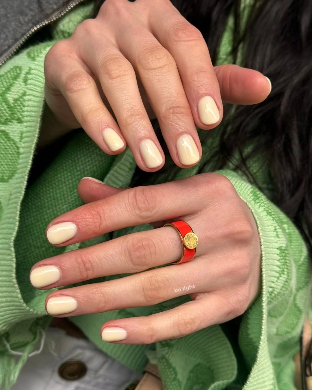 Creamy off-white glossy rounded nails in a short shape