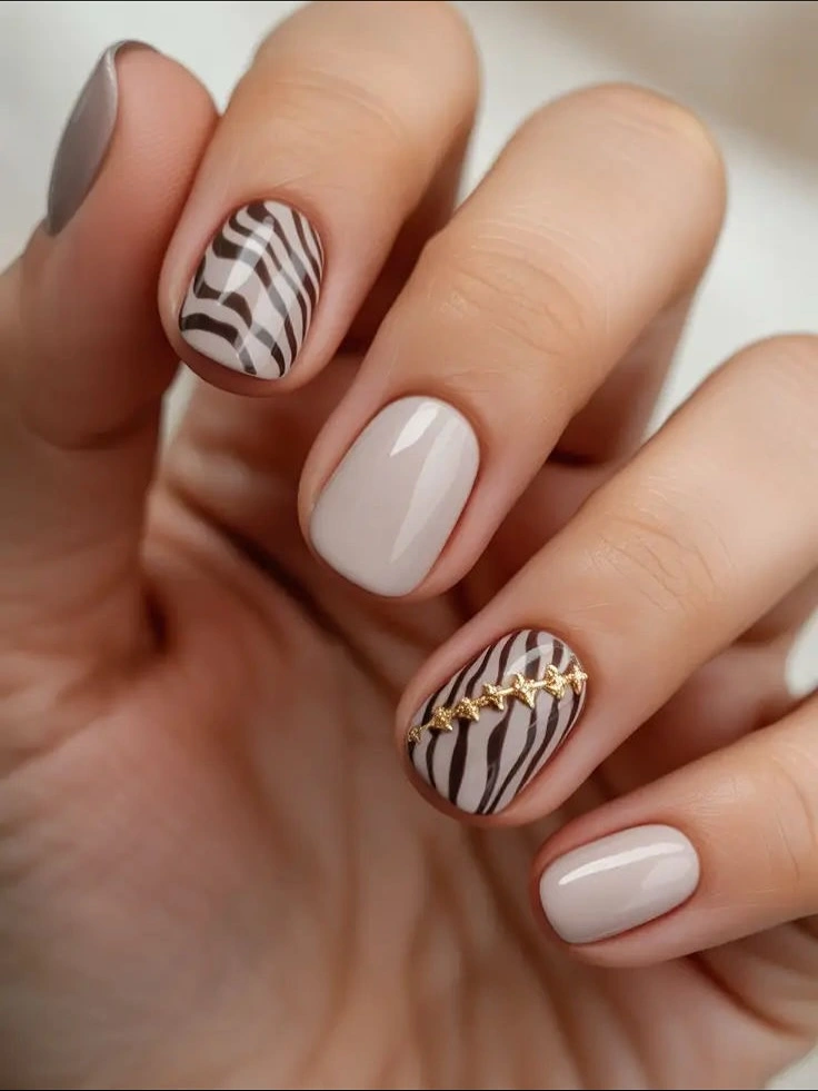 Neutral short nails with curved stripes and warm accent detail