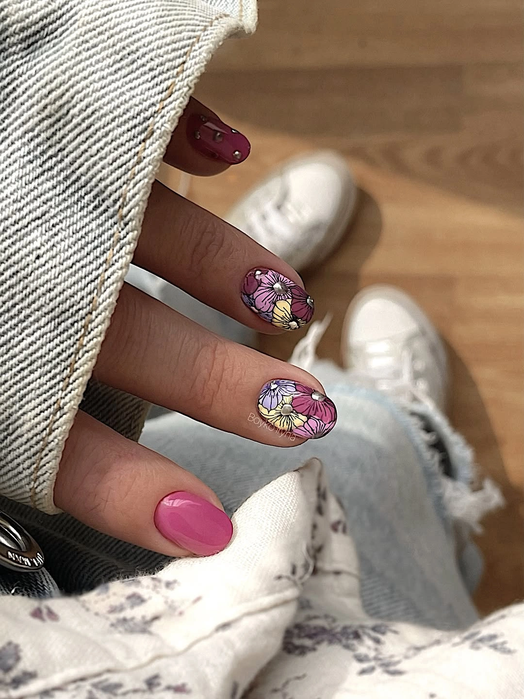 Bright pink nails with one purple floral accent