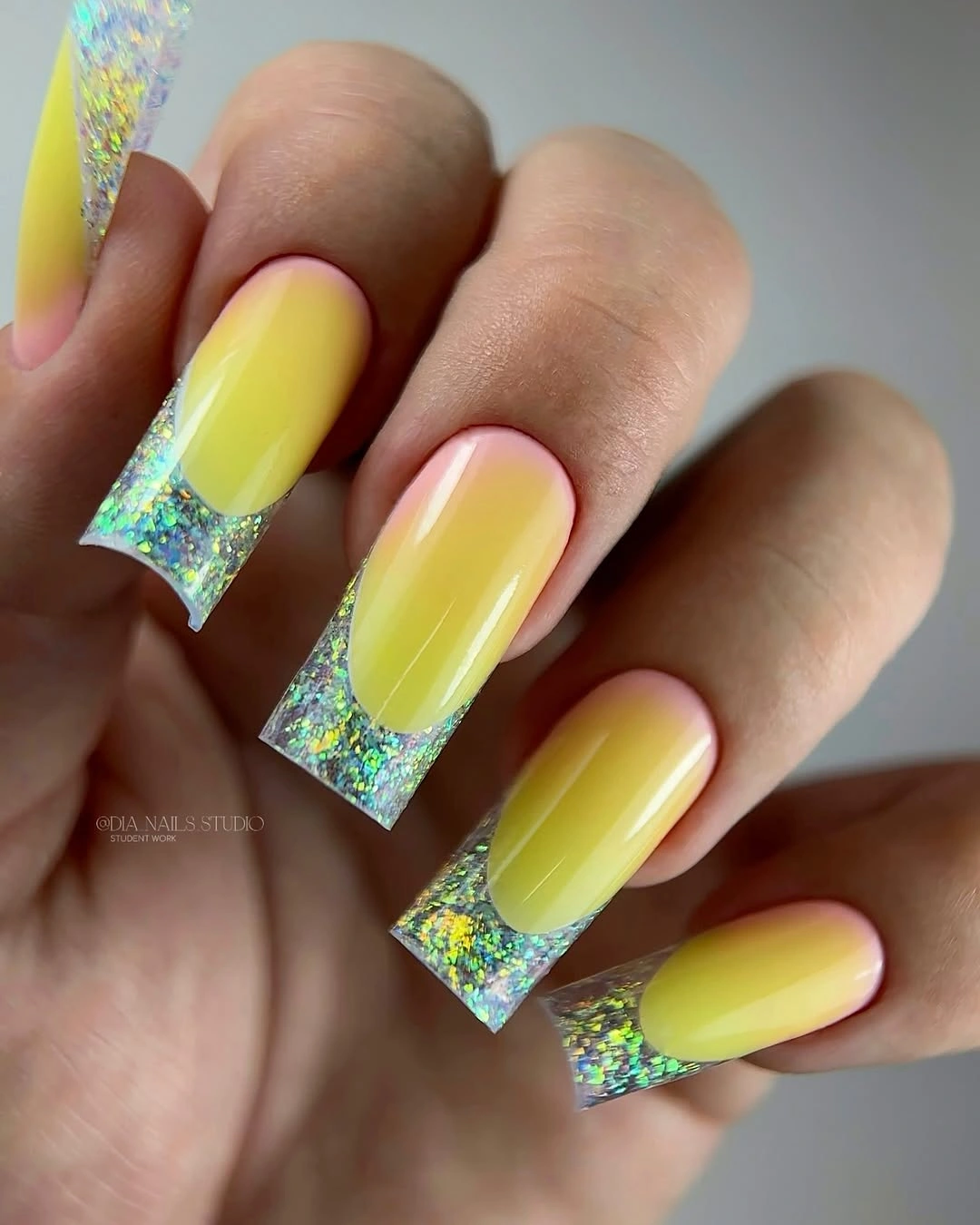 Luminous yellow square nails with iridescent glitter tips