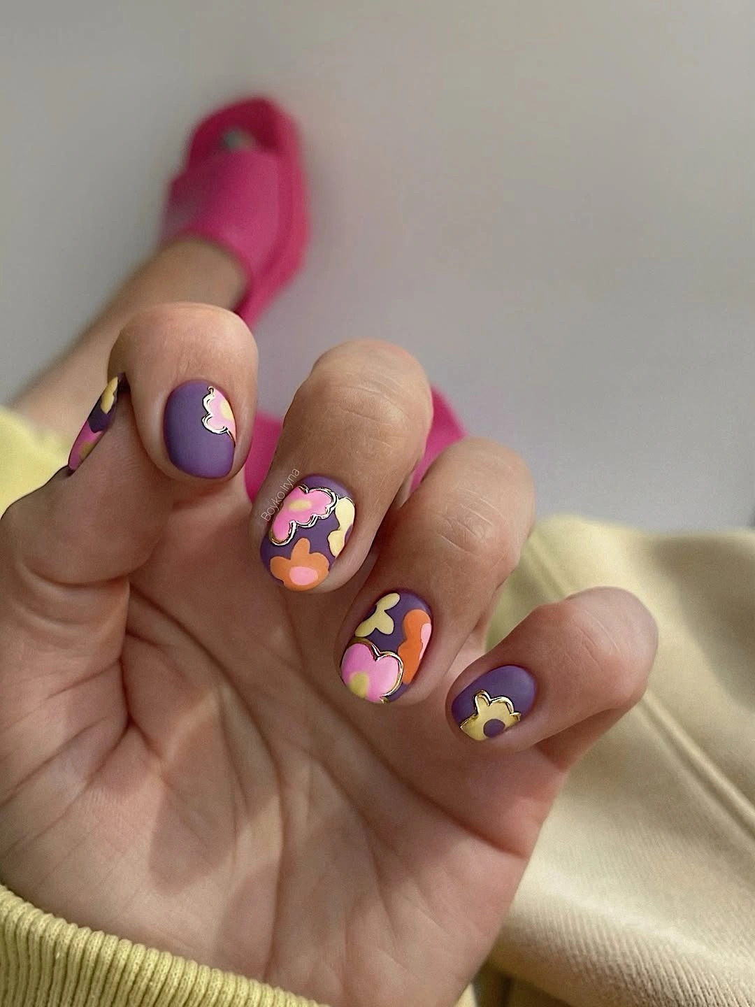 Plum nails with tiny peach yellow and pink flowers