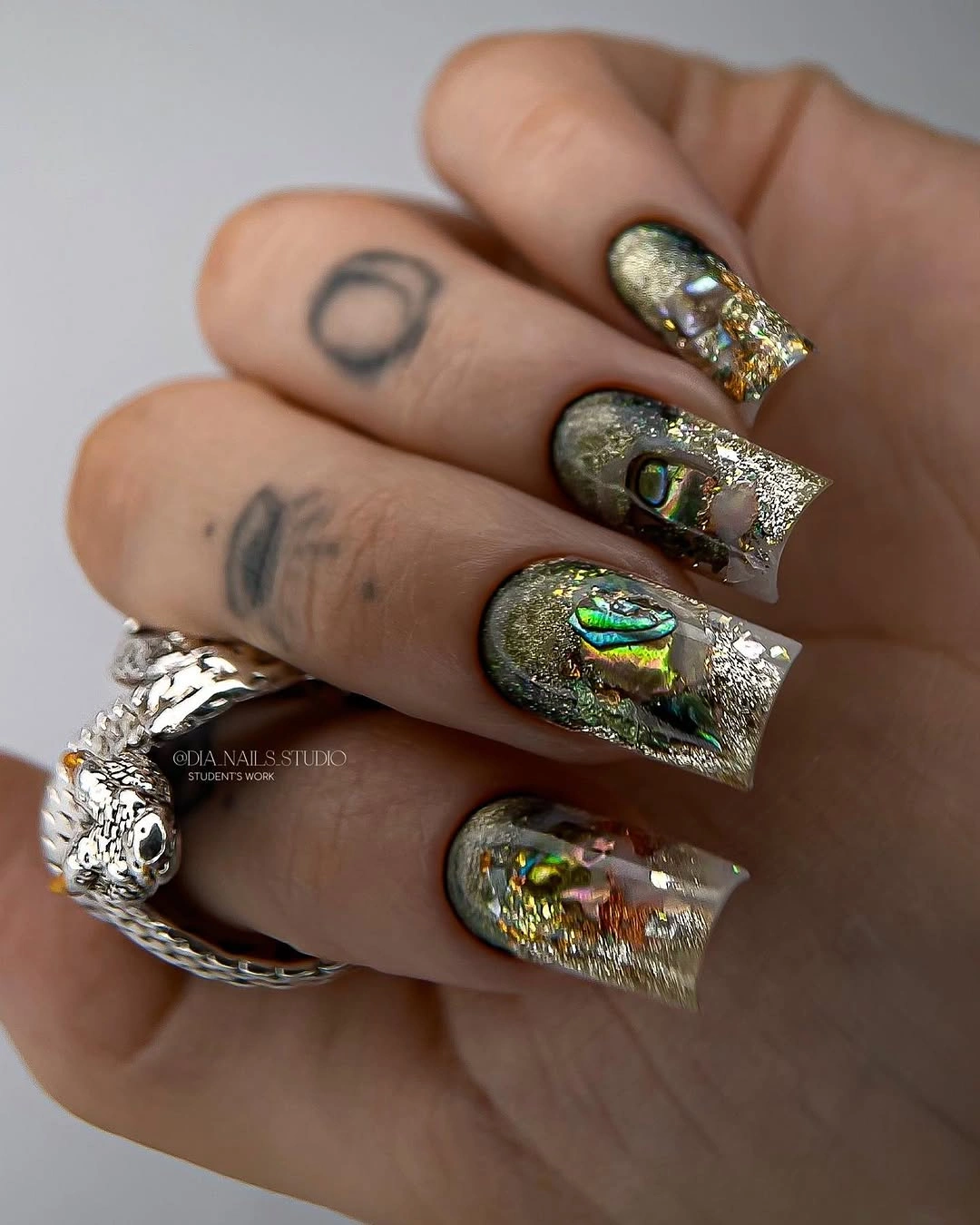 Long nails with dense green gold and silver metallic texture