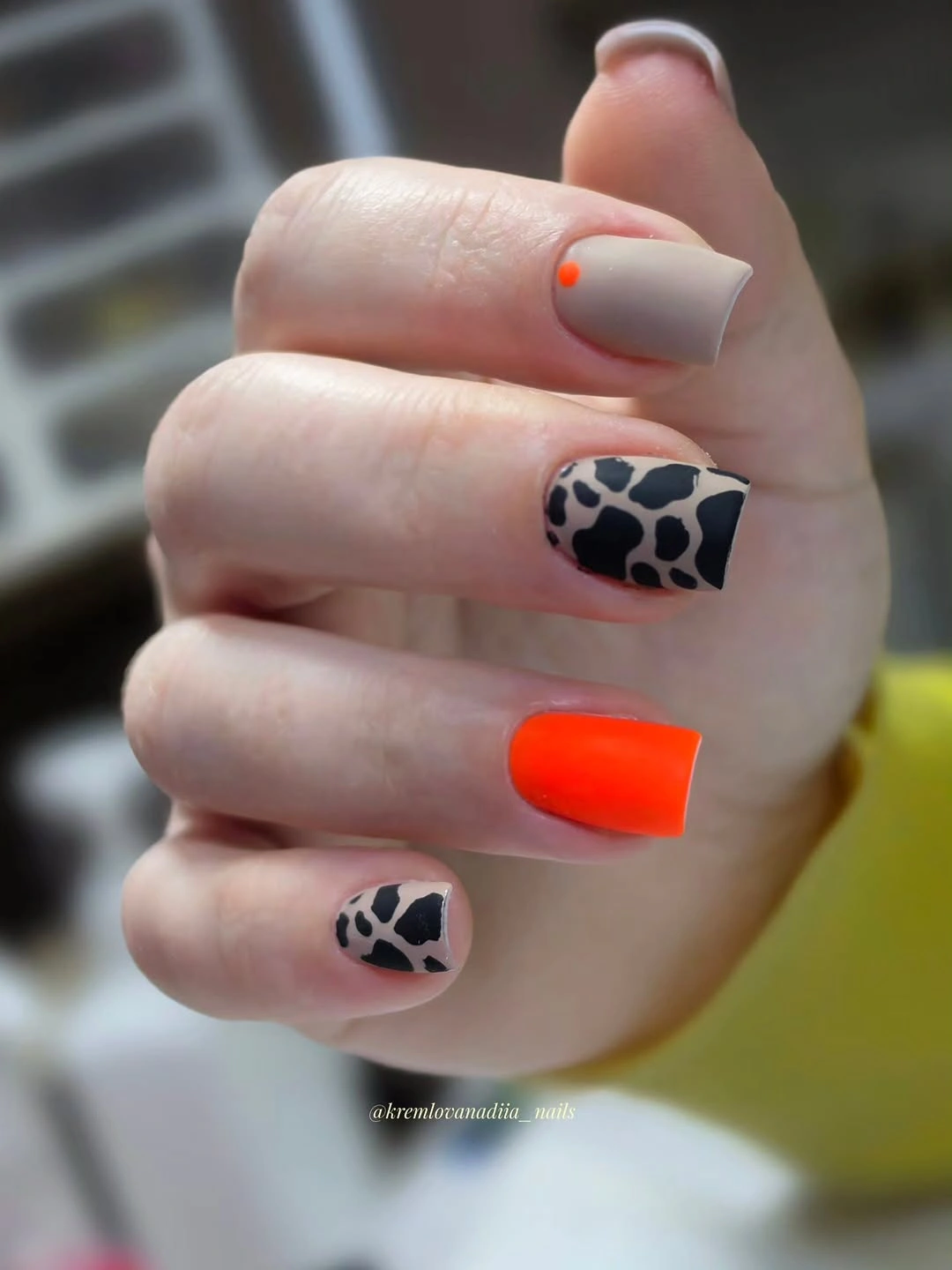 Square nails with orange blocks and black white spotted accents