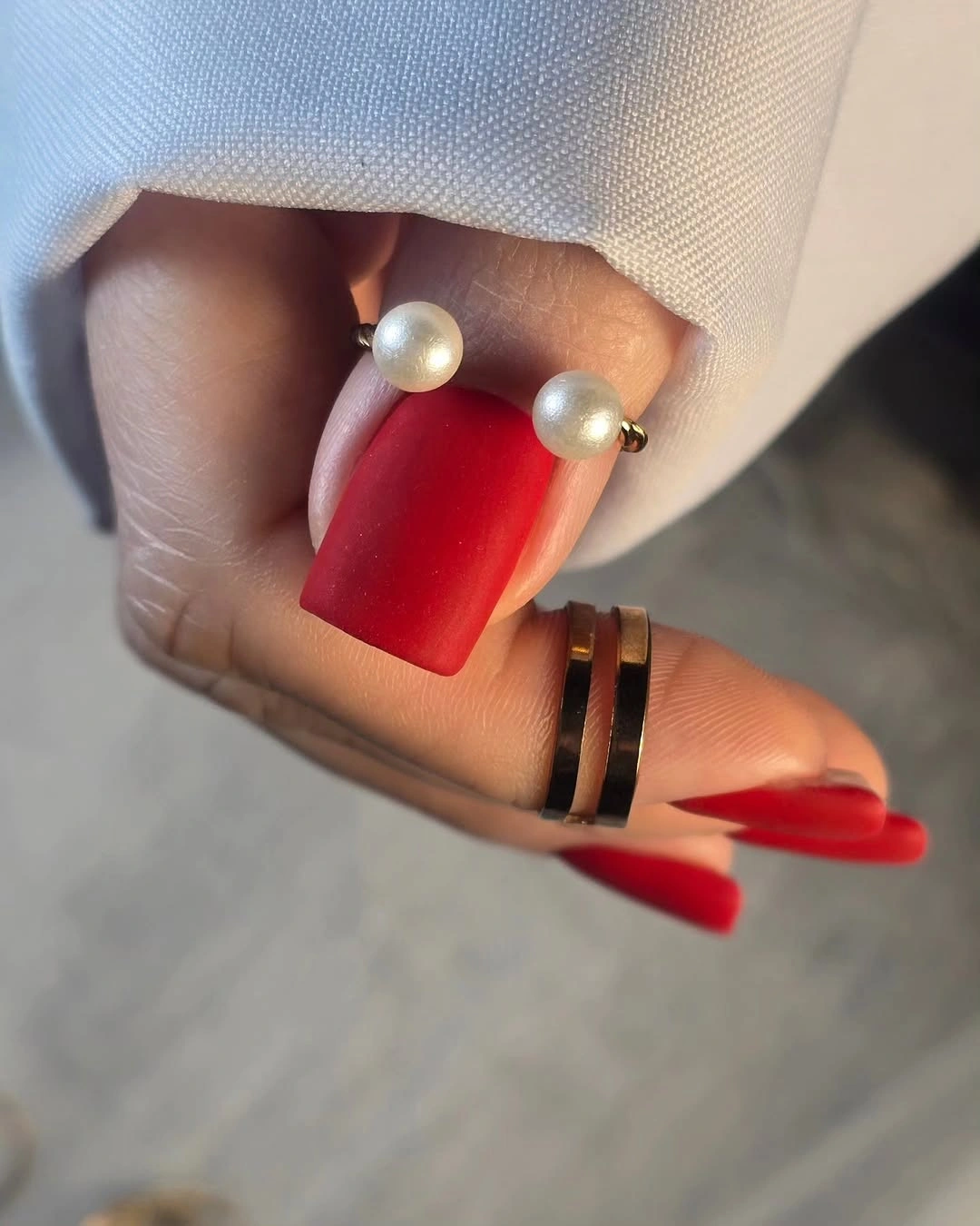 Vivid red square nails with pearl like cuticle accents