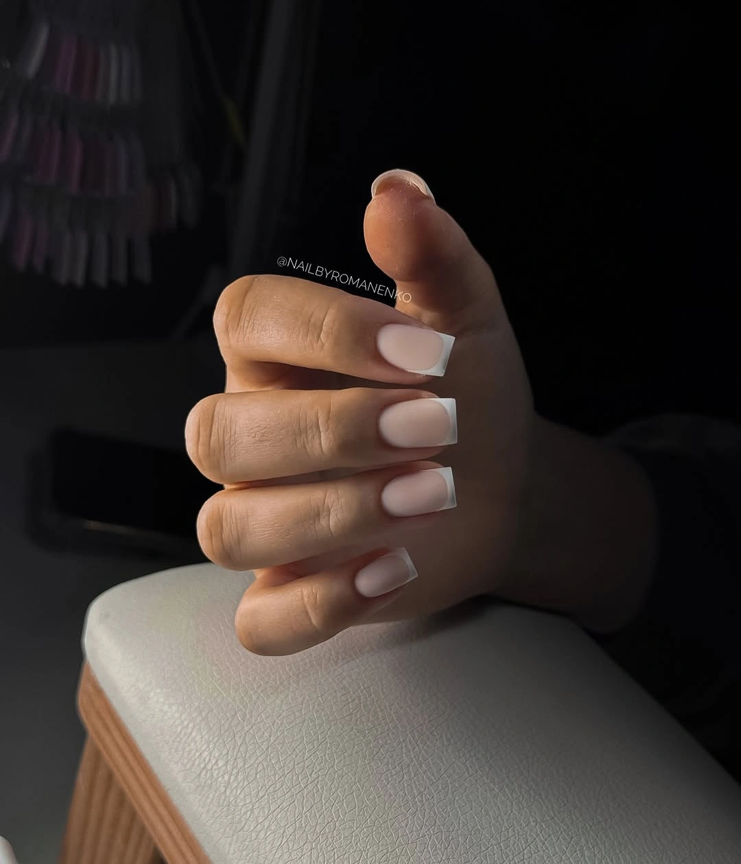 Short pale pink nails with navy curved French tips