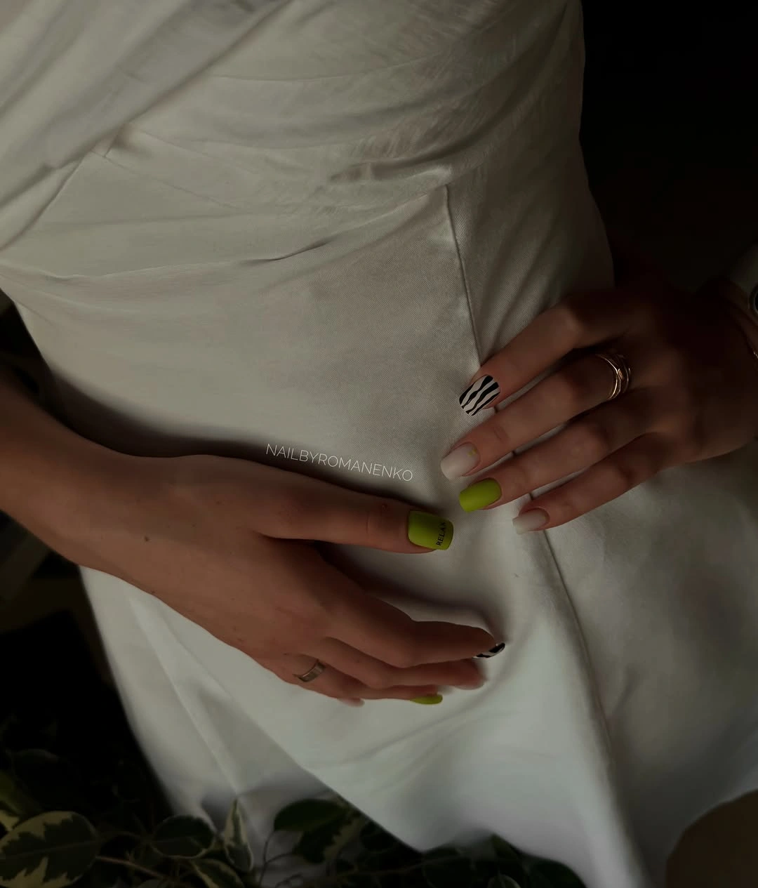 Long nails with lime green accents and pale neutral bases