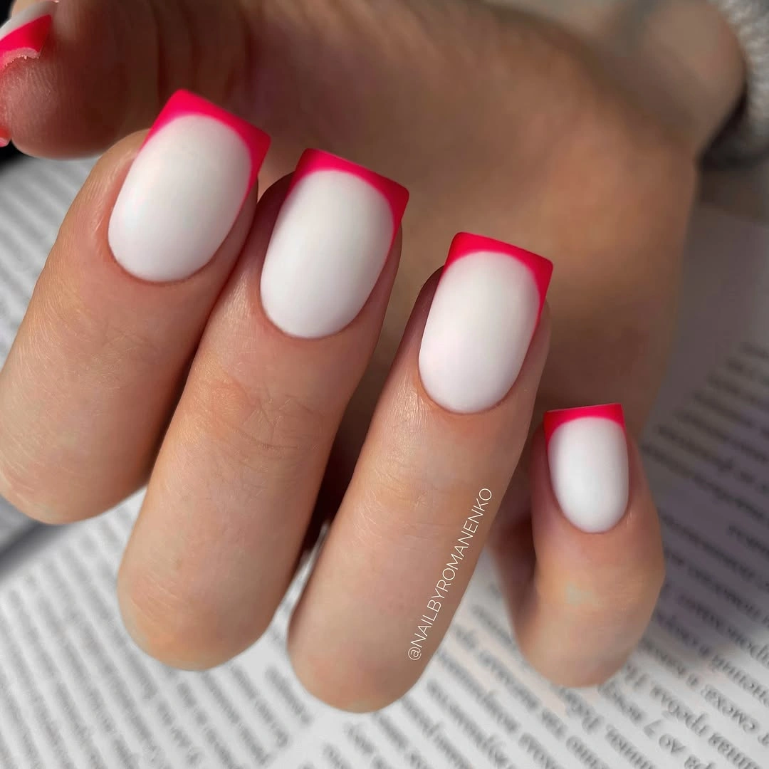 Short square white nails with vivid hot pink framed tips
