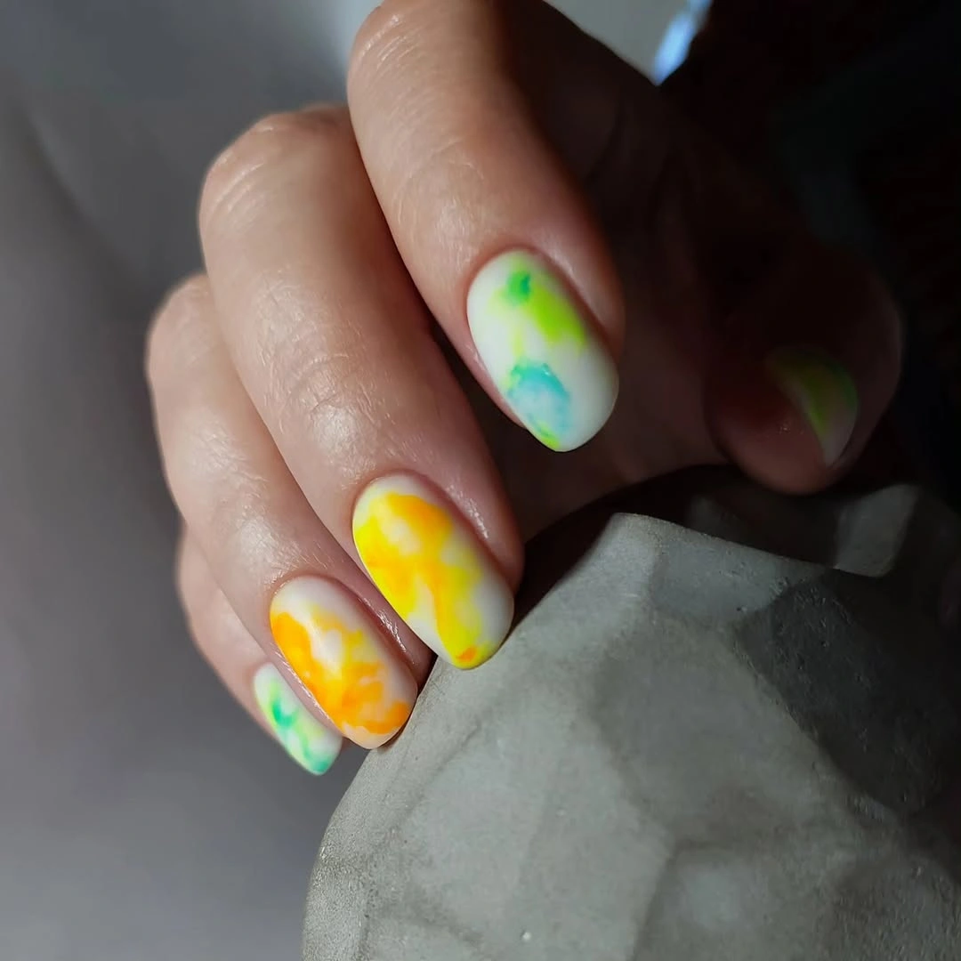 Short nails with cloudy yellow orange lime and aqua patches