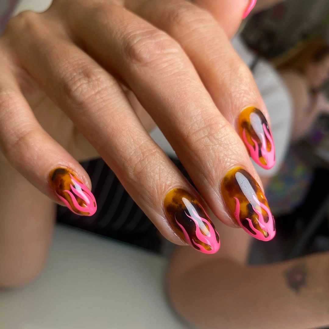 Amber almond nails with hot pink and orange curved lines