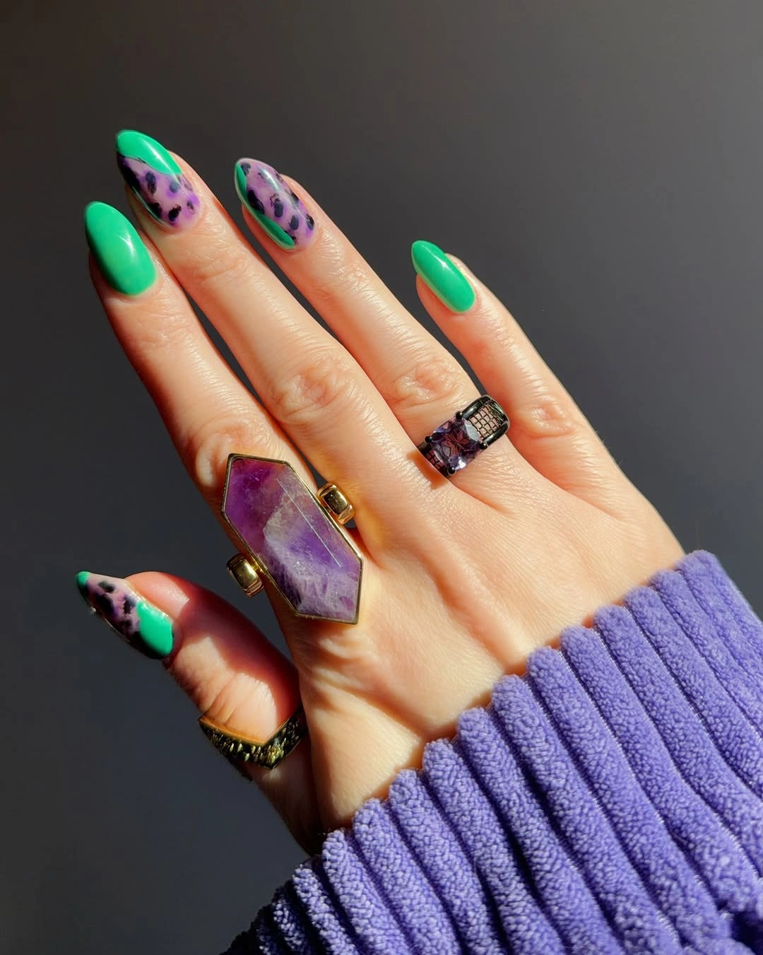 Vivid green nails with purple and dark abstract accents