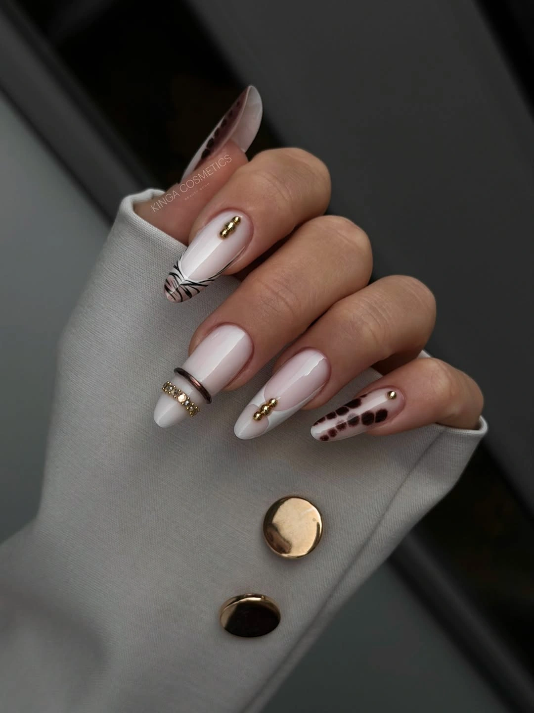 Long almond nails with blush white stripes and gold details
