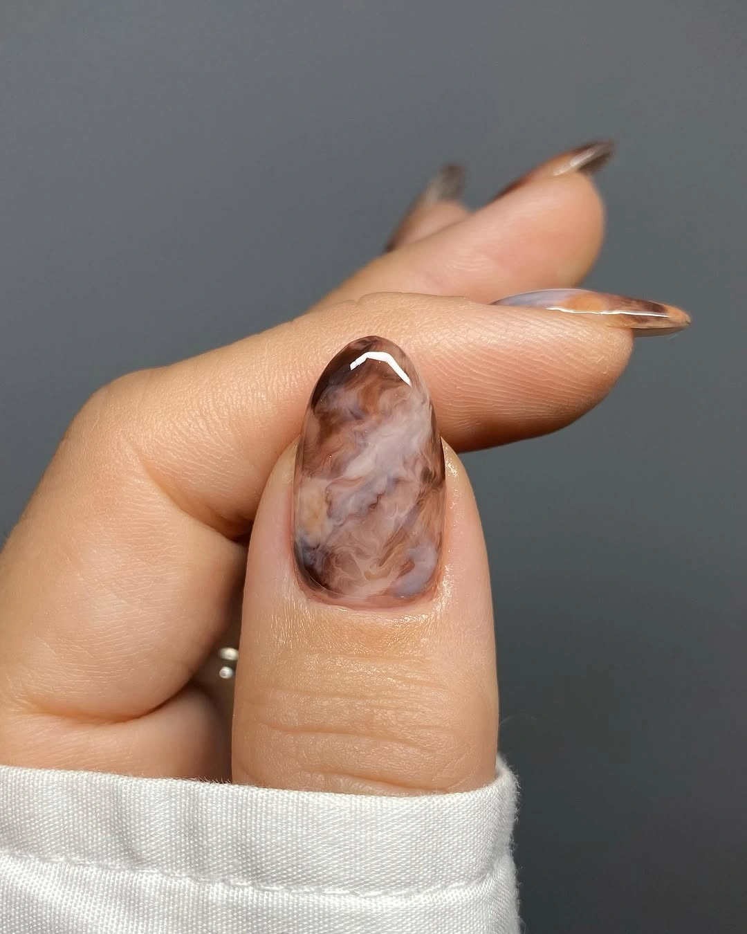 Long almond thumb with translucent brown marble detail