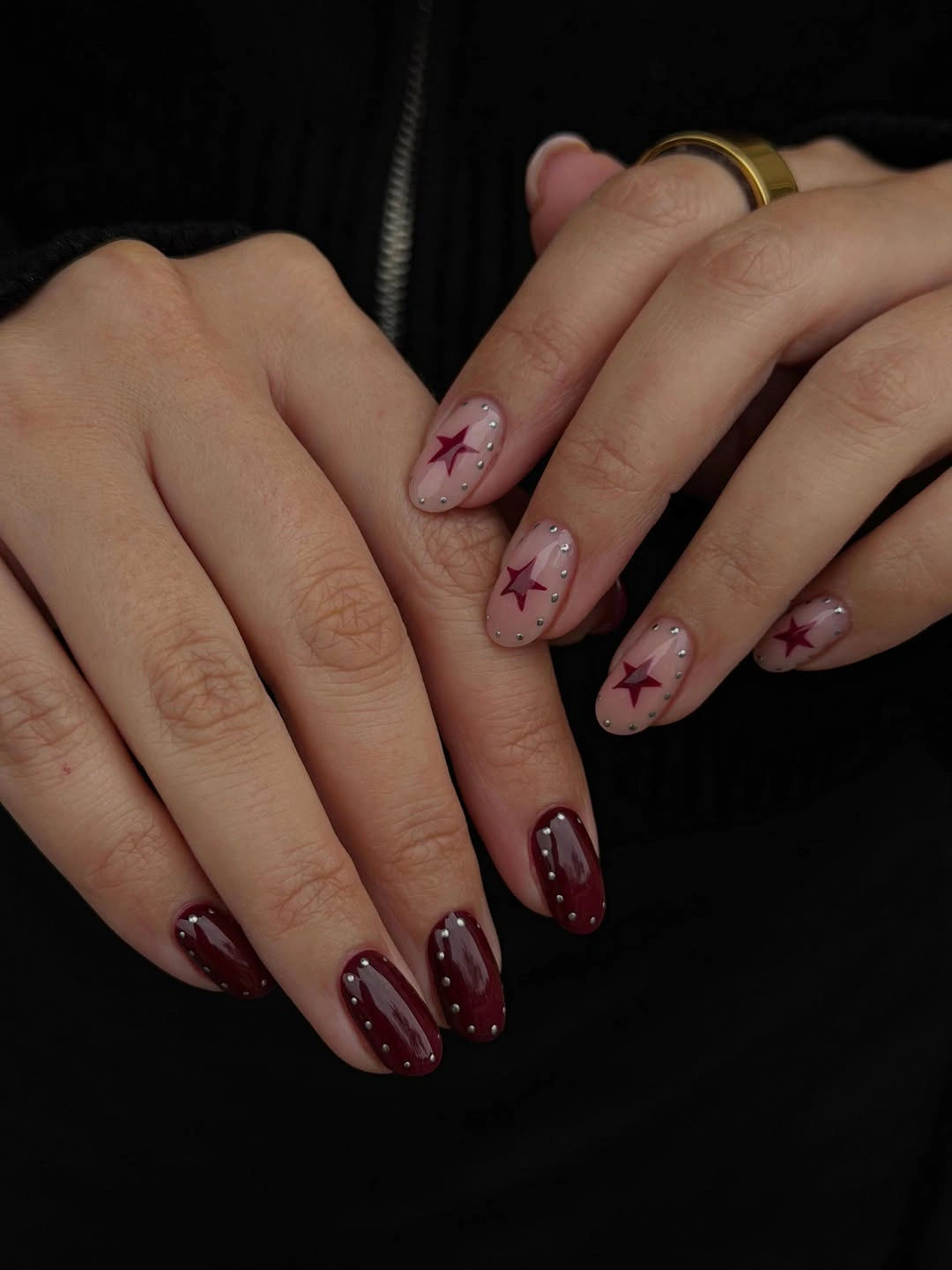 Burgundy nails with pale pink star accent details