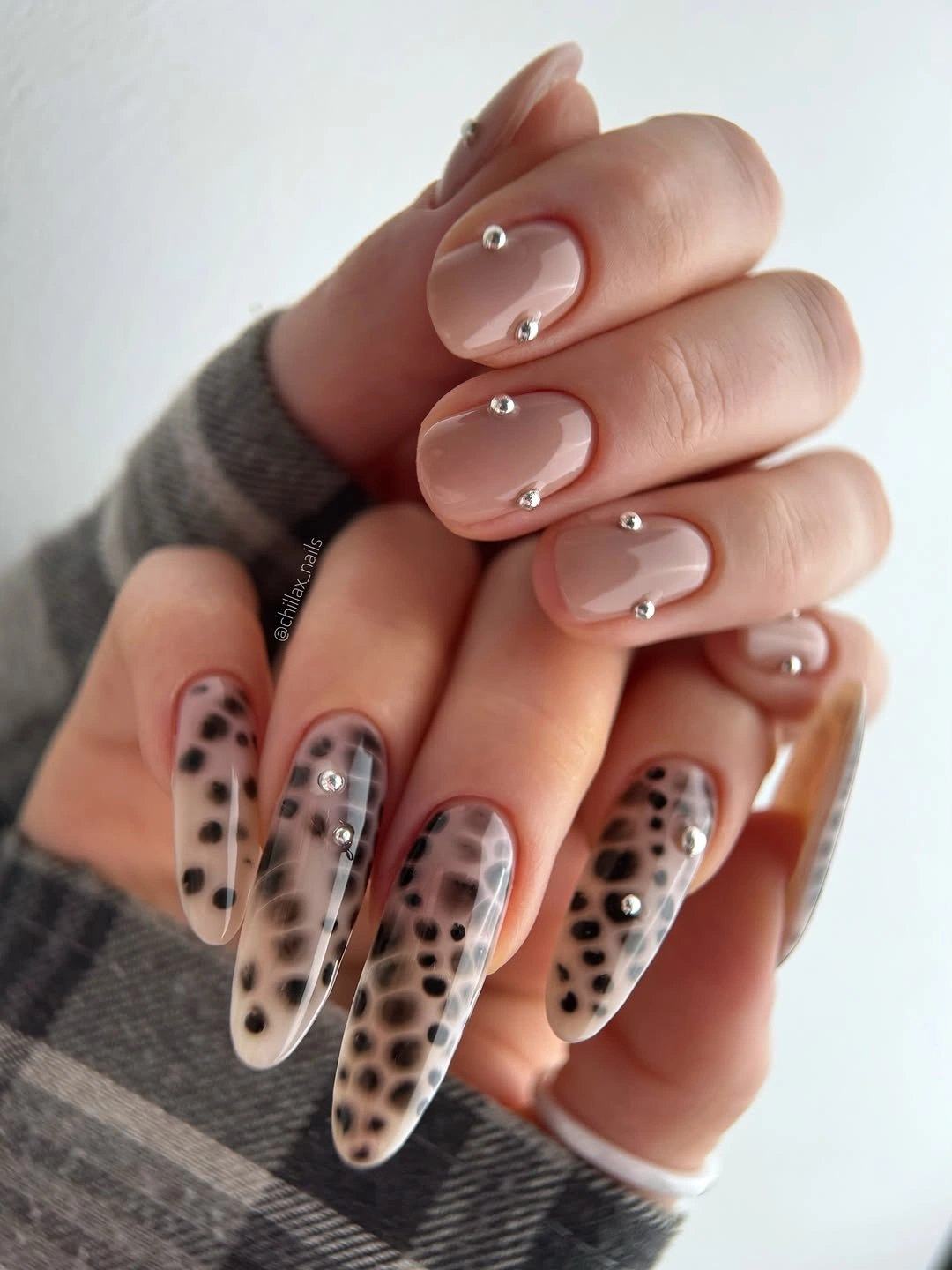 long translucent nails with black spots and tiny pearl accents