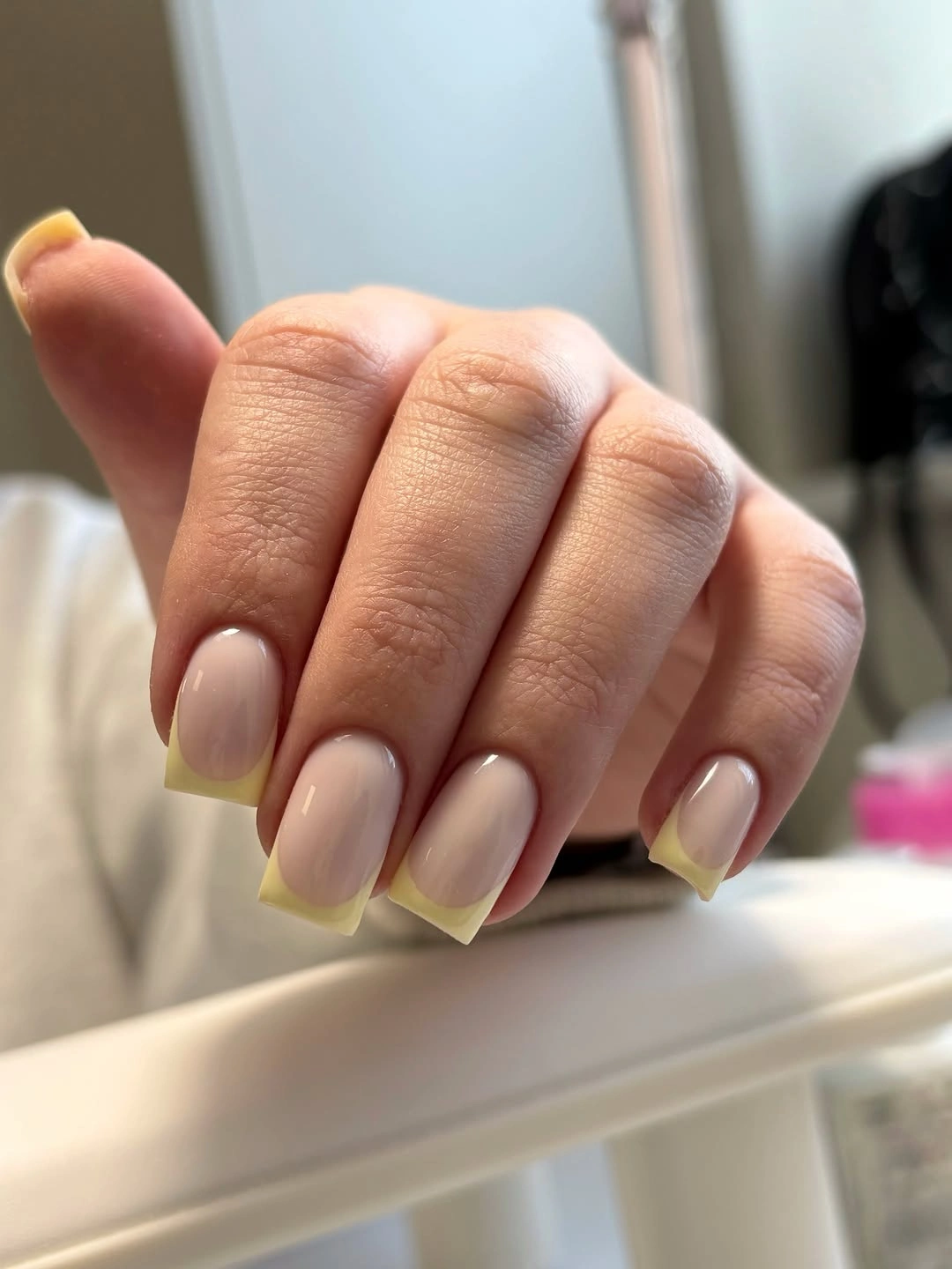 nude square nails with sunny yellow French tips