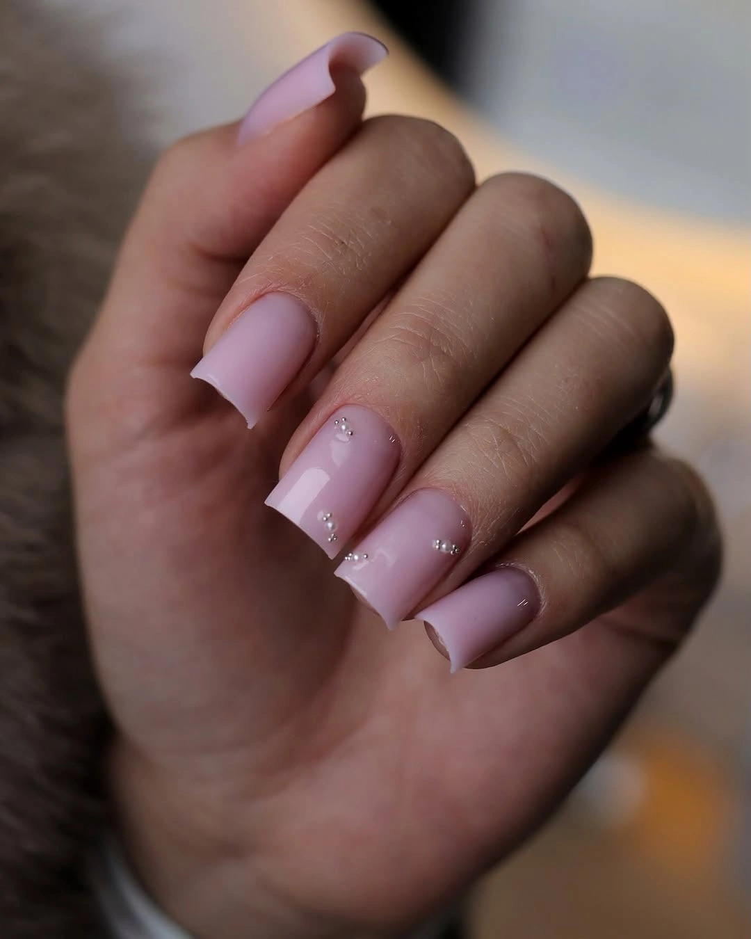 Pale pink square nails with a luminous glitter overlay
