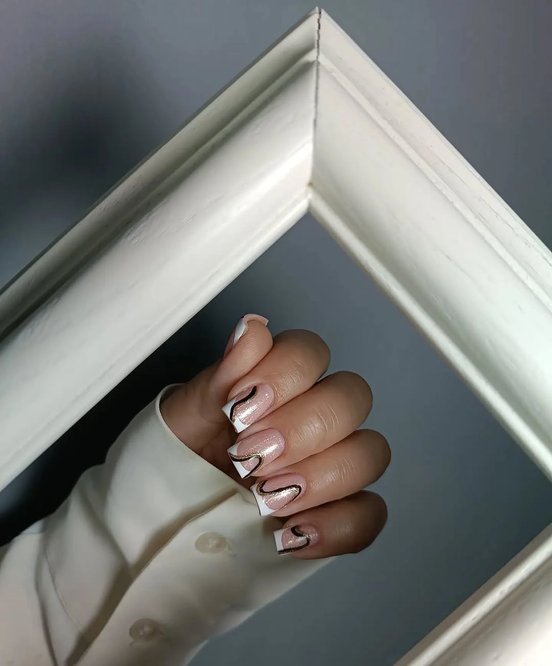Pearly pink square nails with white corners and dark curves