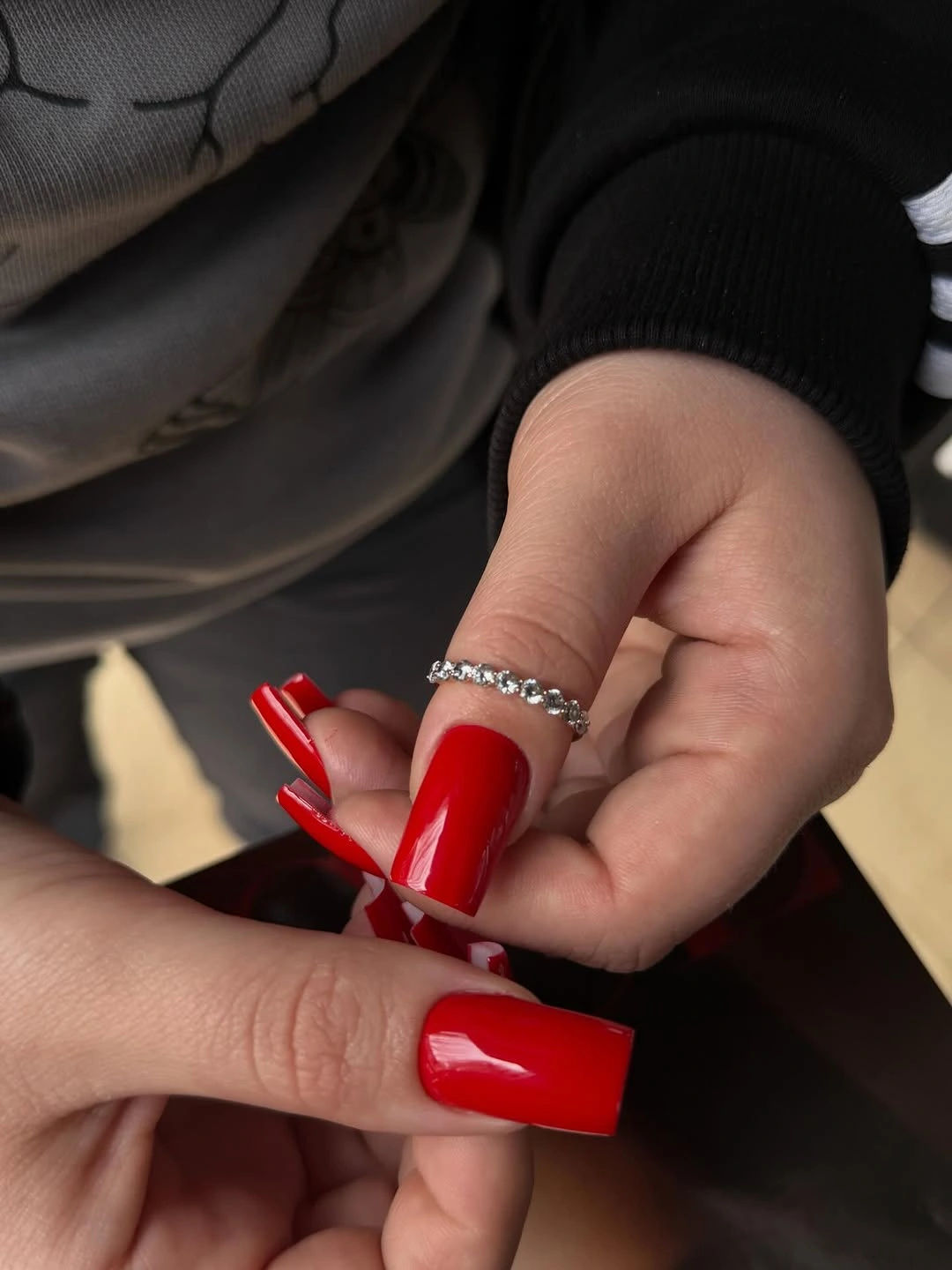 Long glossy red square nails in a clean solid finish