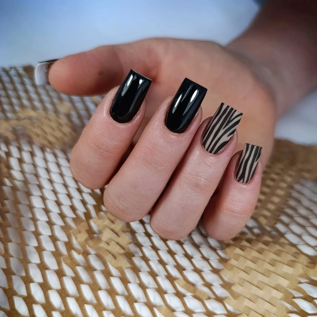 Glossy red square nails with lighter reflective panel accents