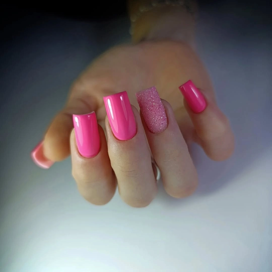 Long almond nails with orange tips and small motifs