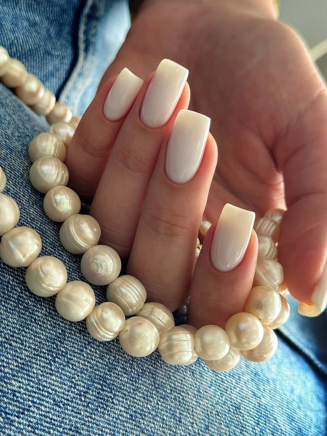 Medium square nails with a smooth creamy white finish