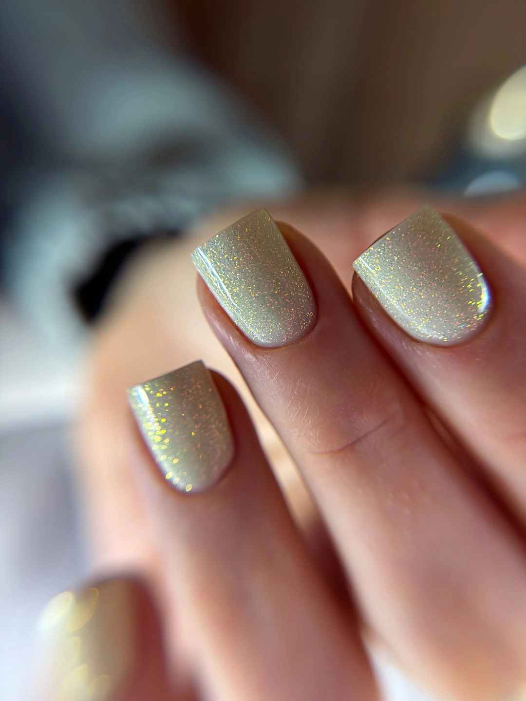 Short square nails with pale green pearly shimmer