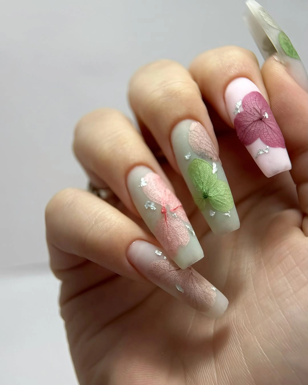translucent botanical nails with pink green leaves