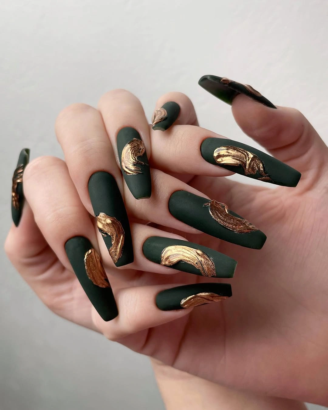 matte olive coffin nails with copper accents