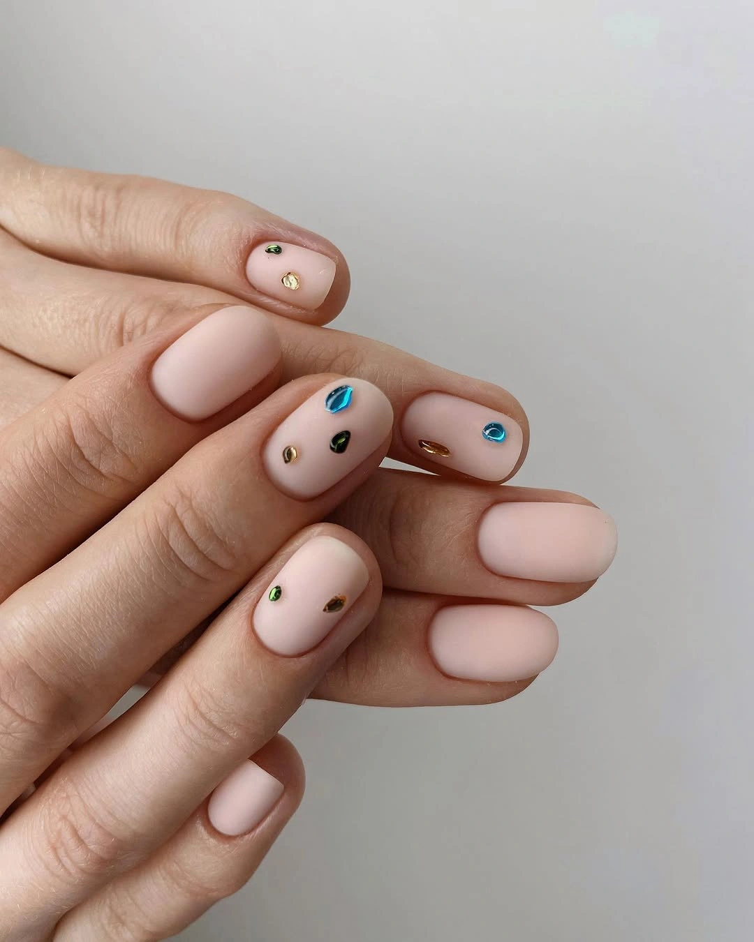 short matte nude nails with tiny color accents