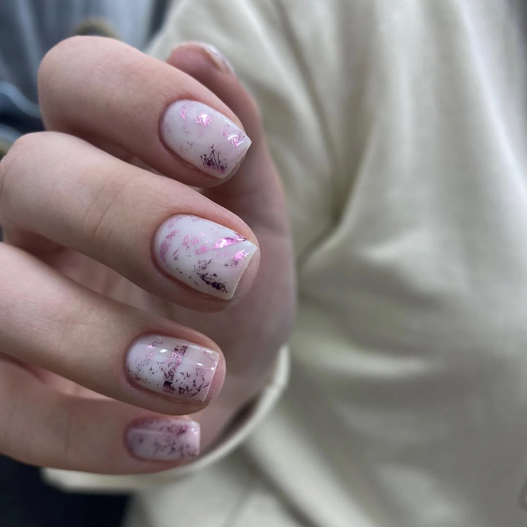 short pale nails with rose speckled flecks