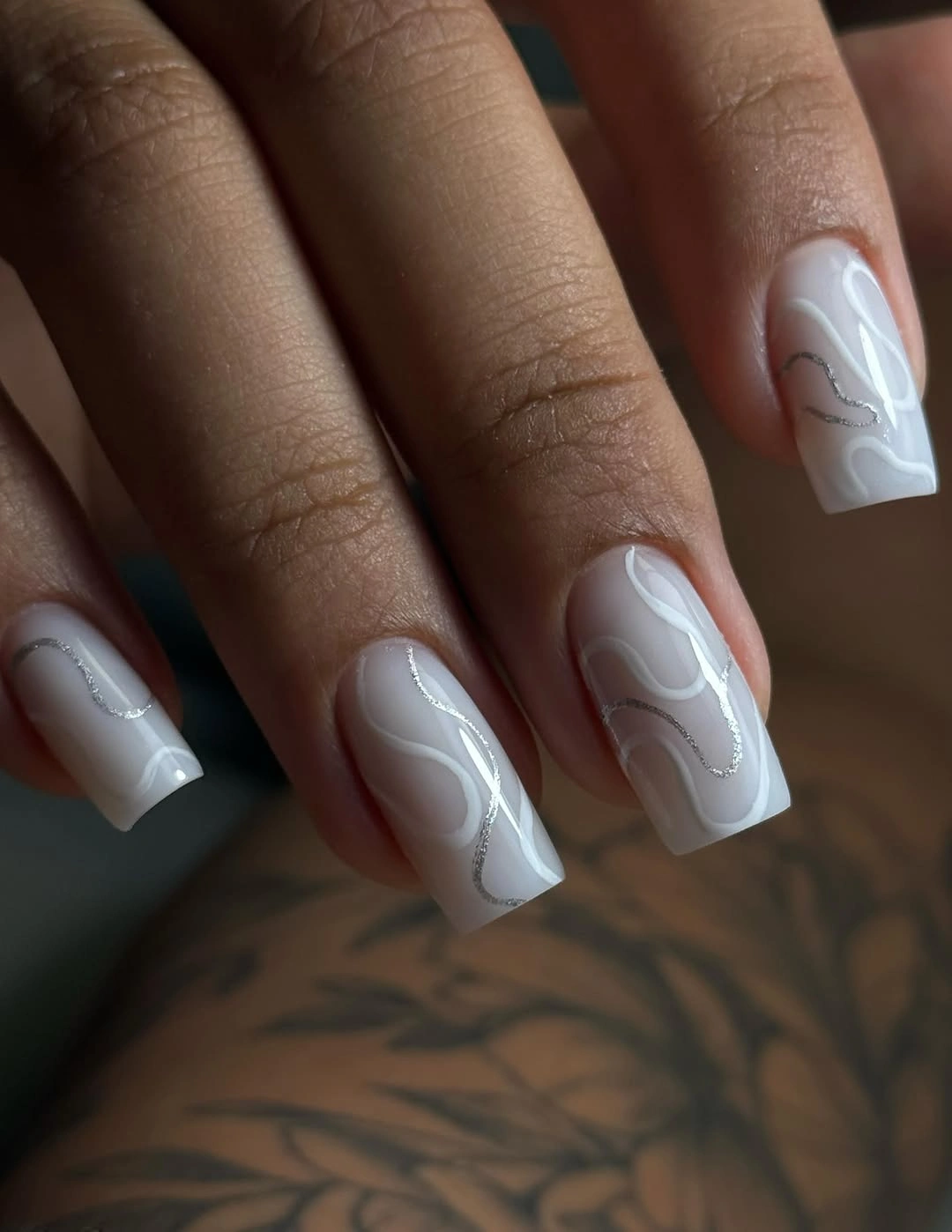 milky white wave nails with silver lines