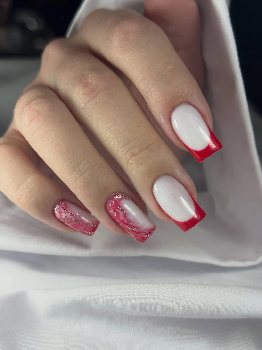red French tips with pink marble accents