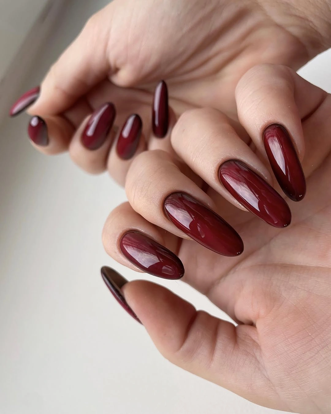 burgundy brown almond nails with glossy finish