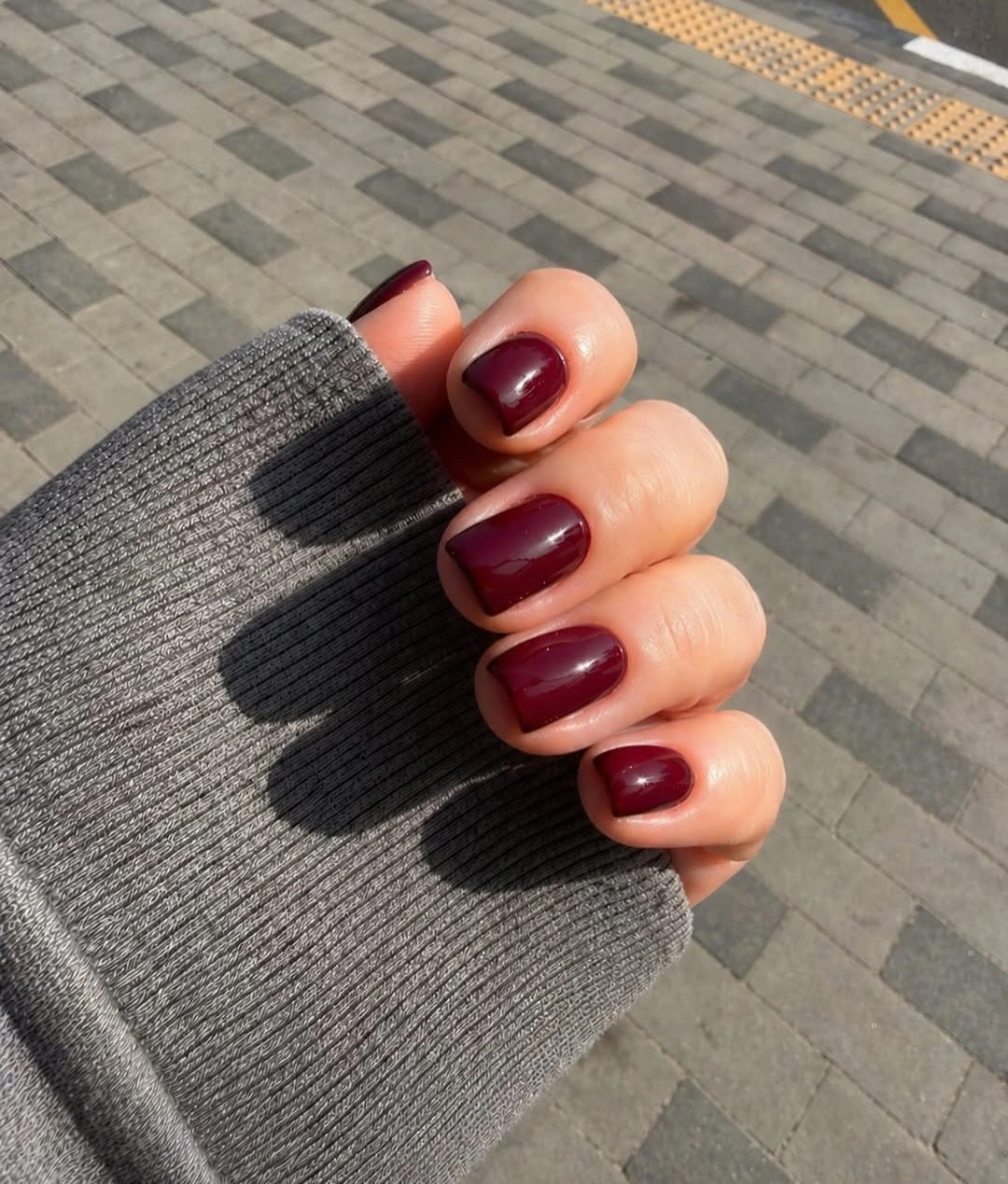 short deep burgundy nails with a polished glossy surface