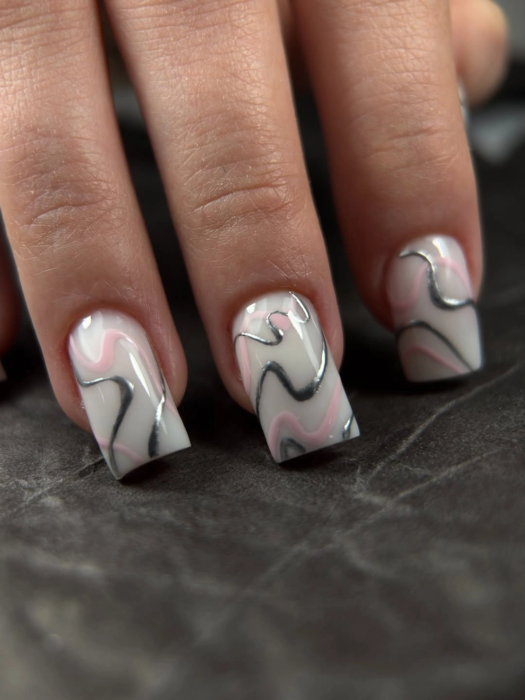short white nails marked with thin black and gray waves
