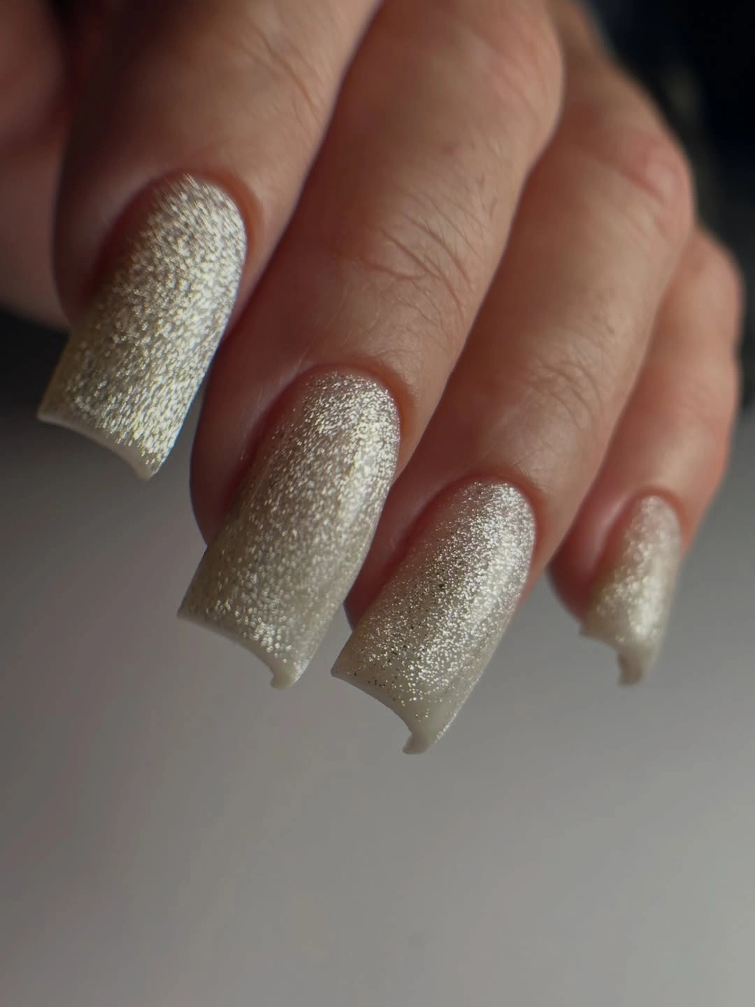 long square nails covered in fine champagne shimmer