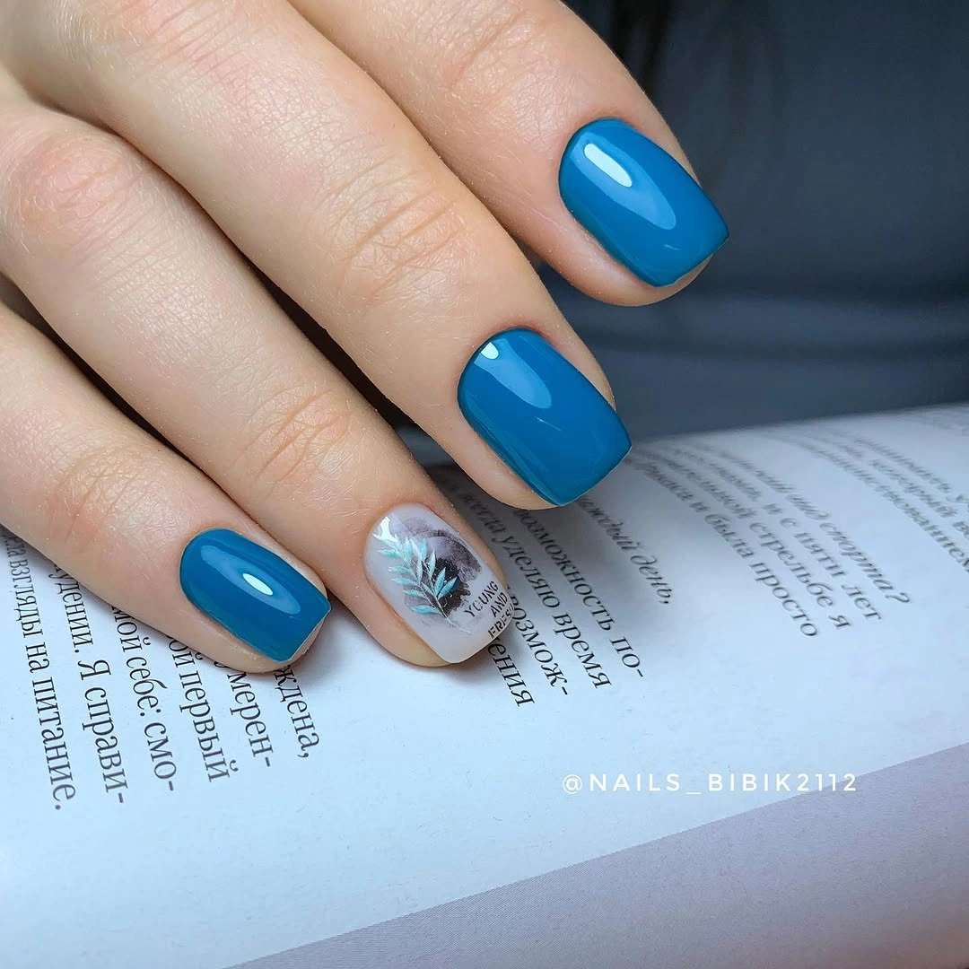 short glossy blue nails with one reflective accent