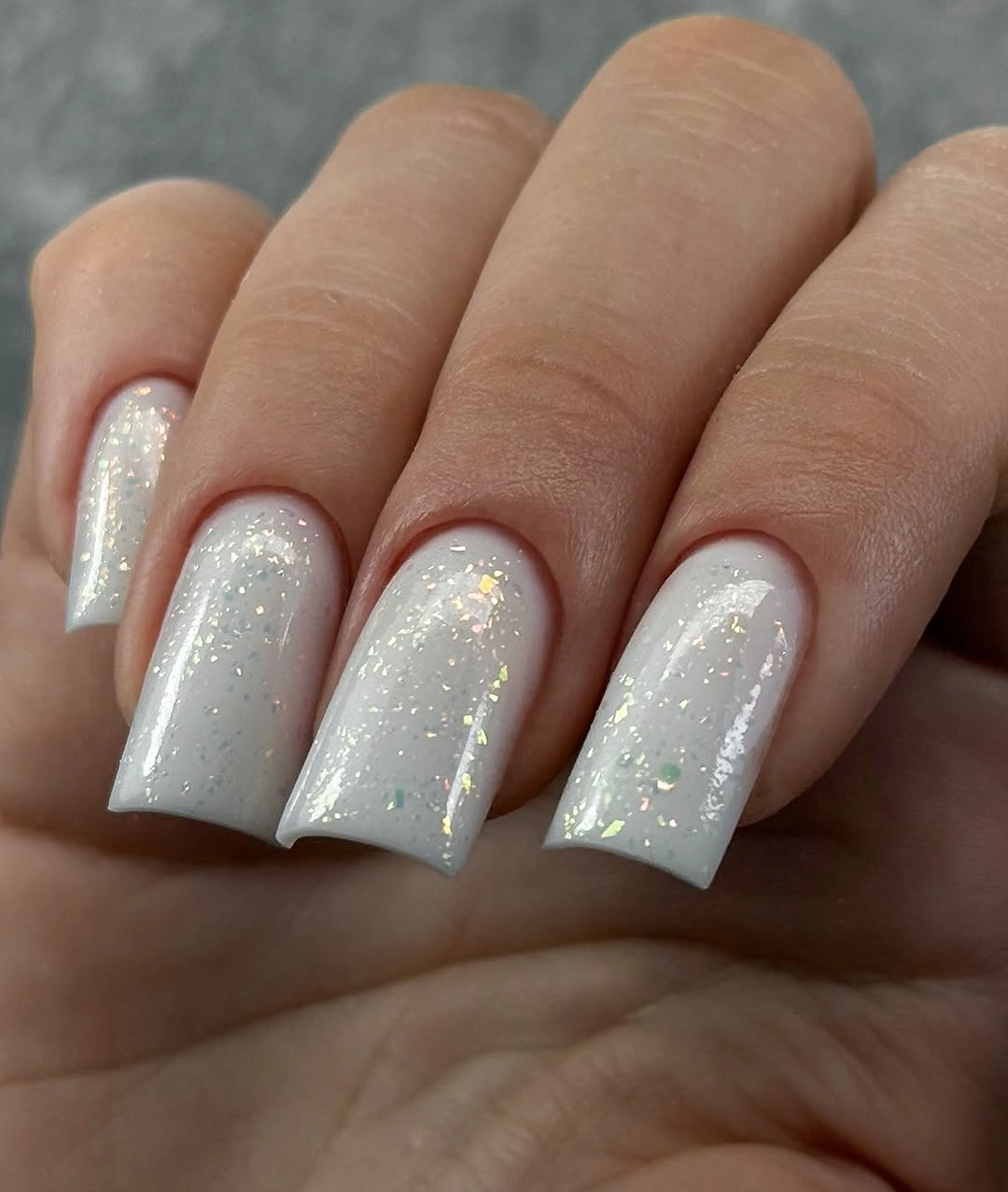 short white nails with a fine gold shimmer